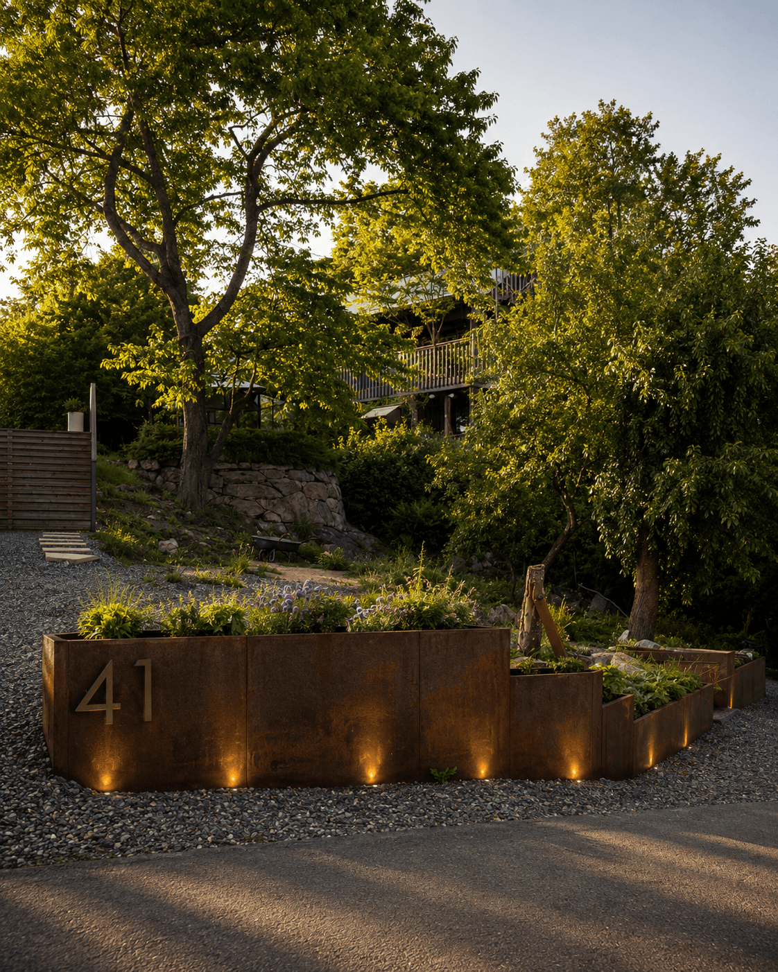 Corten steel raised garden beds uplit at dusk — bespoke commission, Stockholm